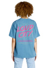 Person wearing a blue t-shirt with 'LOUD CITY Oklahoma' printed on the back.