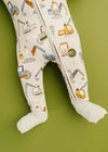Baby legs wearing patterned leggings on a green background