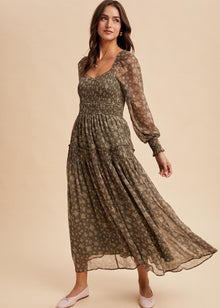  Woman wearing a long, patterned dress on a beige background
