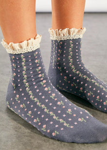  Floral patterned socks with lace trim worn by a person on a neutral background