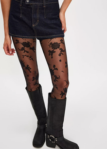  Person wearing black floral tights with black boots on a white background
