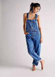  Person wearing a blue denim jumpsuit on a plain background