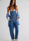Person wearing denim overalls with a plain background