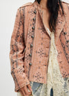 Pink floral patterned jacket with lace overlay on a white background