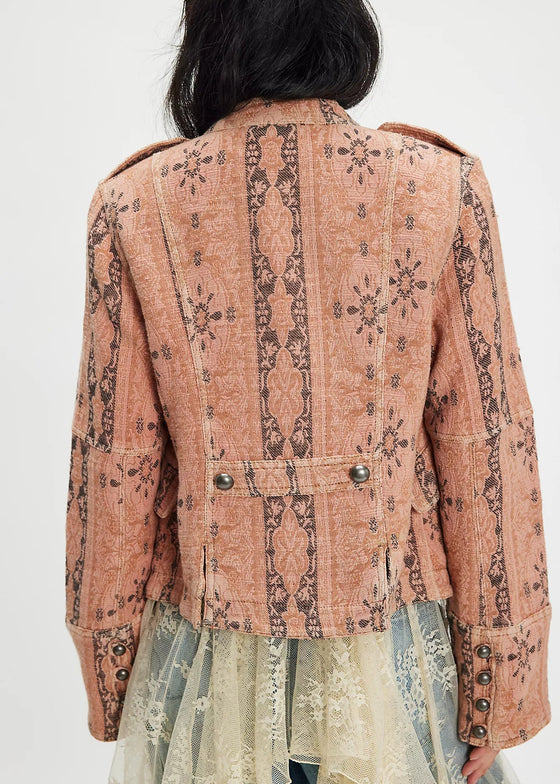 Person wearing a patterned jacket with a plain background