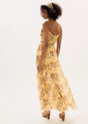 Woman wearing a yellow floral dress on a white background