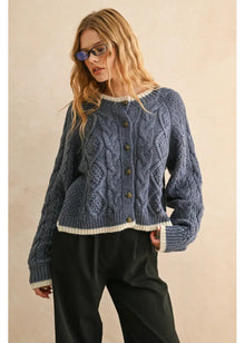 Woman wearing a blue knitted sweater with a beige background