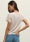 Woman wearing a striped t-shirt and blue jeans against a plain background