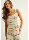 Woman wearing a striped sleeveless top and shorts set on a white background