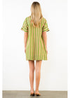 Woman wearing a green and white striped dress on a plain background