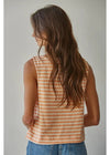 A woman with long brown hair is shown from the back wearing a sleeveless top with horizontal peach and white stripes, paired with blue jeans, against a plain light gray background.