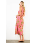 Woman wearing a pink floral dress on a white background