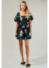 Woman wearing a black floral dress on a white background