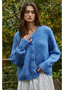  Woman wearing a blue knitted sweater with a natural background