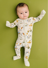 Baby wearing a onesie with vehicle prints on a green background