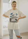 Person wearing a graphic t-shirt with a cat design indoors