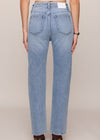 Light blue jeans worn by a person on a beige background