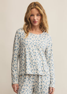  Woman wearing a floral pajama set against a beige background