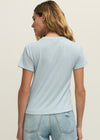 Person wearing a light blue t-shirt and jeans on a plain background