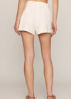 White lace shorts worn by a person on a plain background